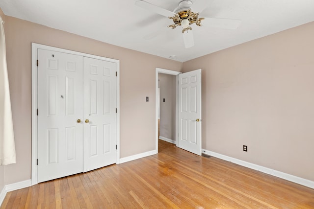 unfurnished bedroom featuring a closet, baseboards, light wood-style flooring, and a ceiling fan