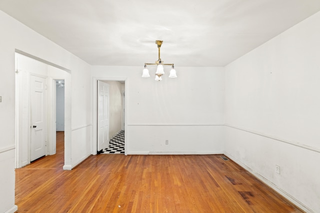 unfurnished dining area featuring light wood-style flooring