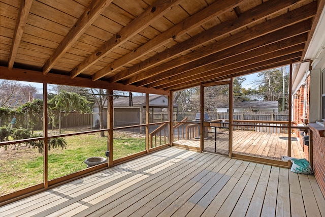 unfurnished sunroom with beam ceiling and wood ceiling