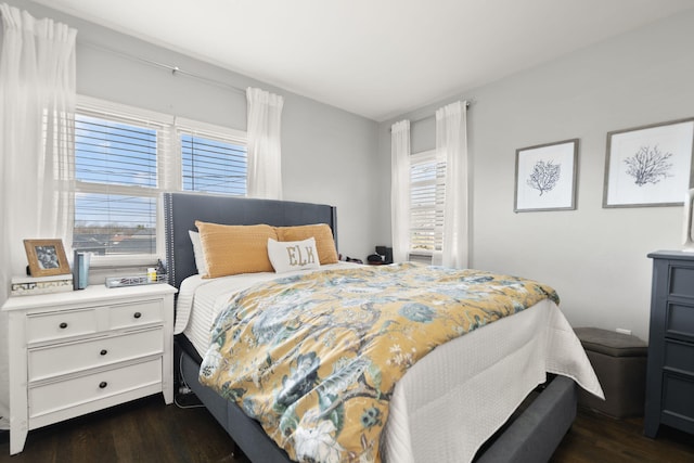 bedroom featuring dark wood-style floors and multiple windows