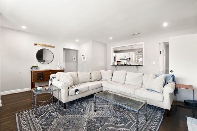 living area with recessed lighting, visible vents, baseboards, and dark wood-type flooring