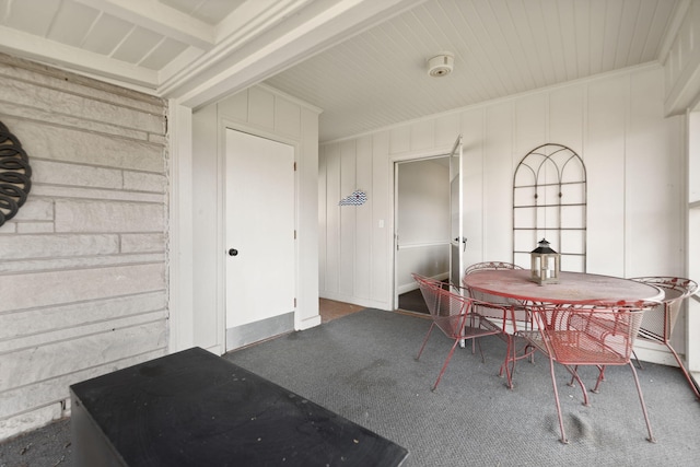 carpeted dining space featuring ornamental molding