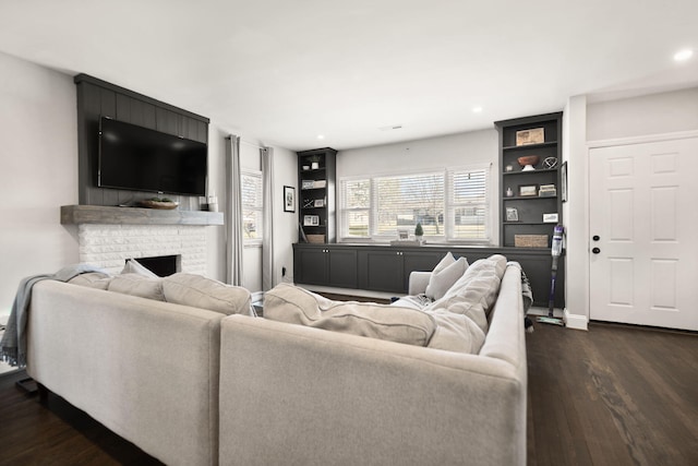 living area with dark wood-style floors, recessed lighting, a fireplace, and baseboards