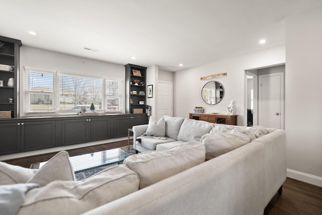 living area with recessed lighting, visible vents, baseboards, and dark wood finished floors