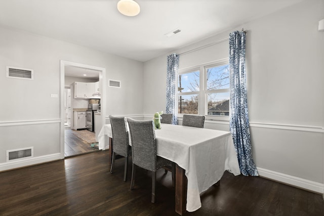 dining space featuring dark wood finished floors and visible vents