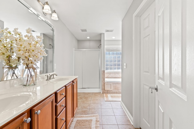 bathroom featuring tile patterned flooring, visible vents, a sink, a stall shower, and double vanity
