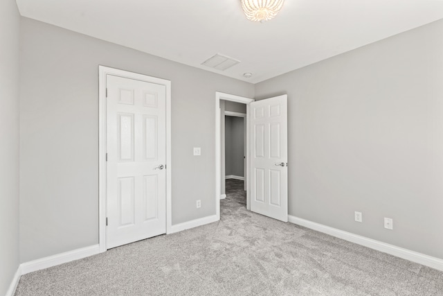 unfurnished bedroom featuring visible vents, baseboards, and carpet