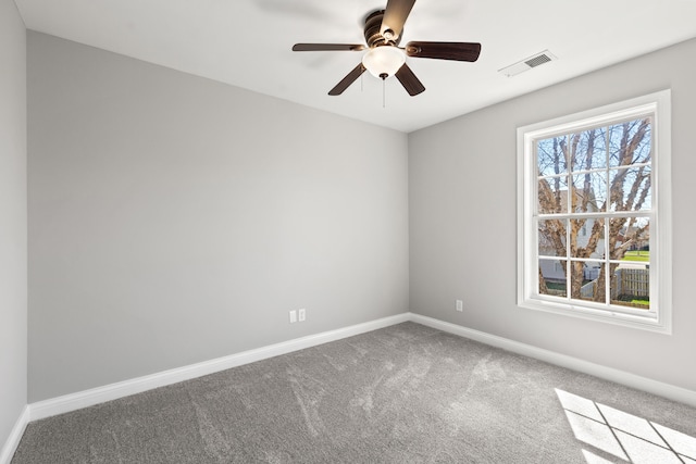 empty room with visible vents, baseboards, a ceiling fan, and carpet