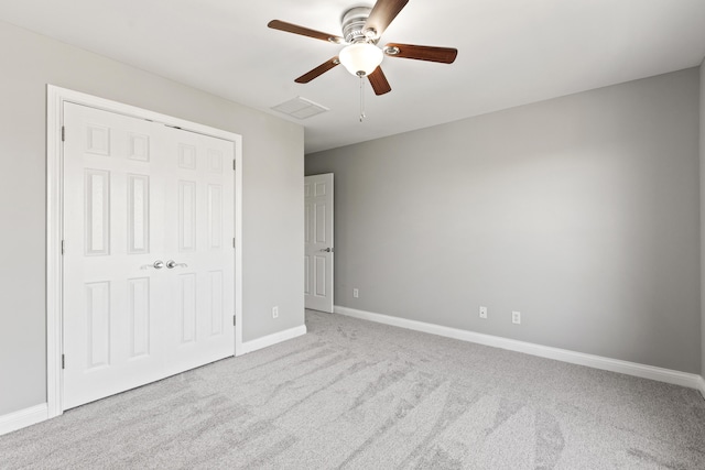 unfurnished bedroom with visible vents, baseboards, a closet, a ceiling fan, and carpet flooring