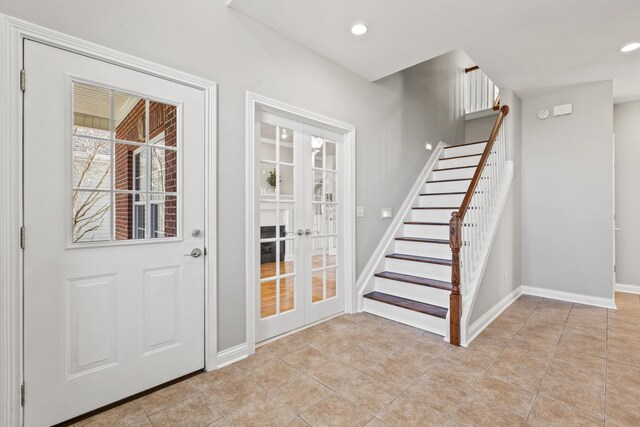 interior space with recessed lighting, light tile patterned flooring, stairs, french doors, and baseboards