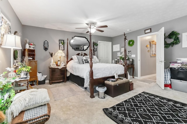 carpeted bedroom featuring ceiling fan and baseboards