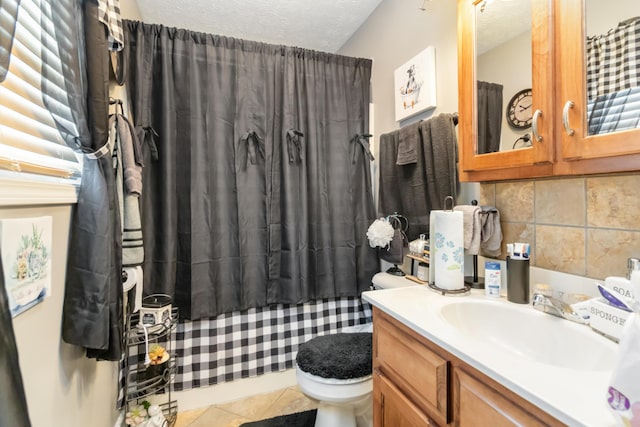 bathroom featuring tile patterned floors, toilet, backsplash, a textured ceiling, and vanity