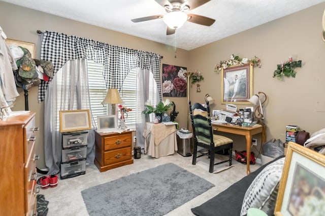 home office featuring light carpet and ceiling fan