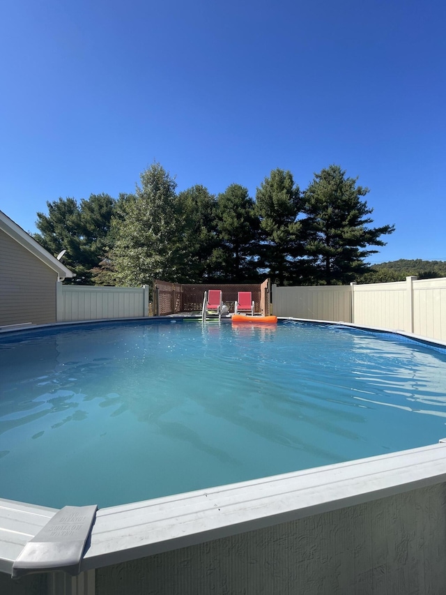 view of swimming pool featuring a fenced in pool and fence