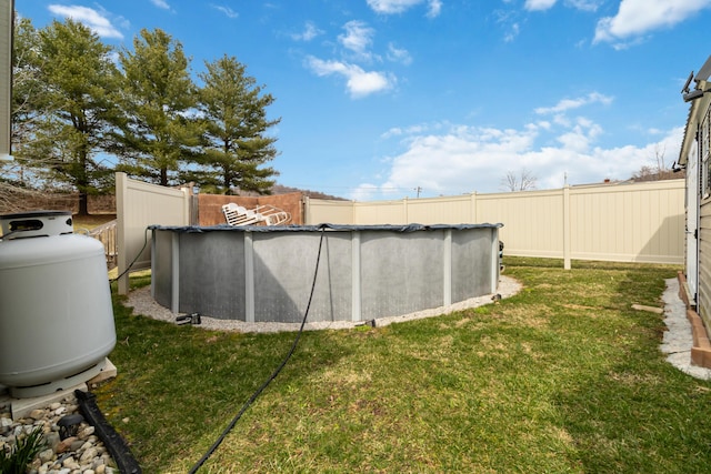 view of yard featuring an outdoor pool and fence