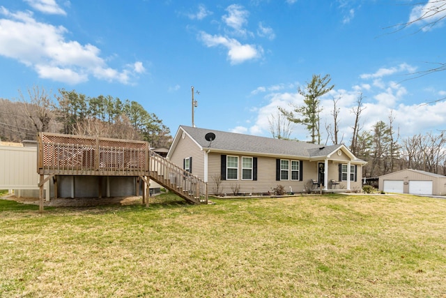 rear view of house with stairway, fence, a yard, an outdoor structure, and a garage