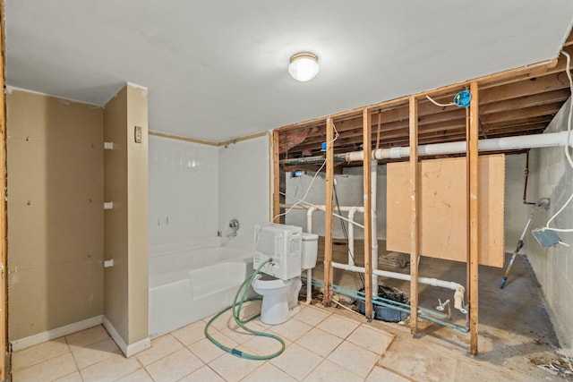 full bathroom featuring toilet and a bath