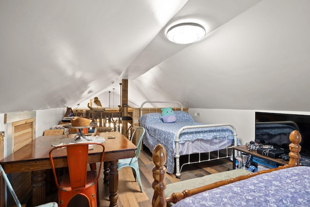 bedroom featuring lofted ceiling and wood finished floors