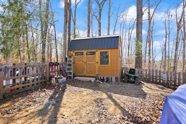 view of shed featuring fence