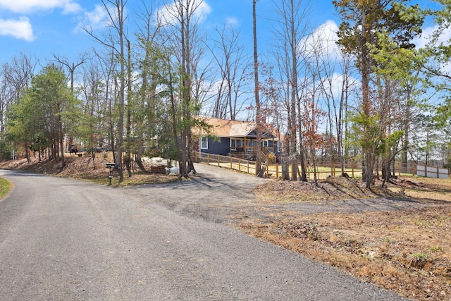 view of front of home with fence and driveway