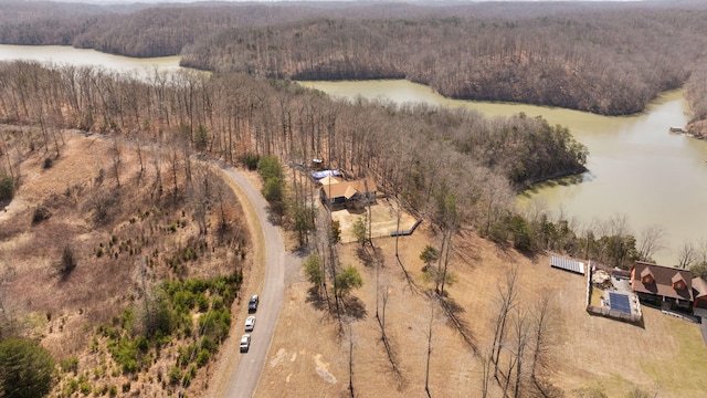 aerial view featuring a wooded view and a water view