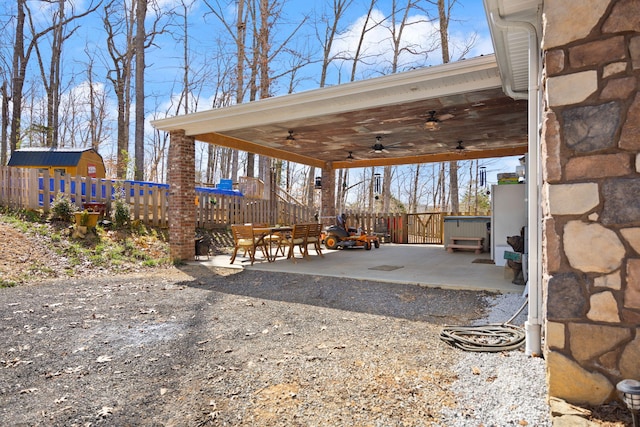 view of patio / terrace with fence and ceiling fan