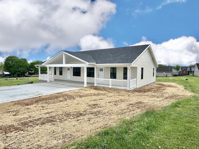 1403 Kit Cowan Rd, Somerset, KY 42503 - view of front facade with driveway, a carport, a shingled roof, covered porch, and a front lawn