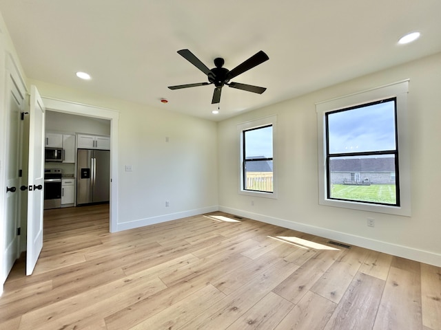 1403 Kit Cowan Rd, Somerset, KY 42503 - unfurnished bedroom featuring recessed lighting, baseboards, light wood-style floors, and stainless steel fridge with ice dispenser