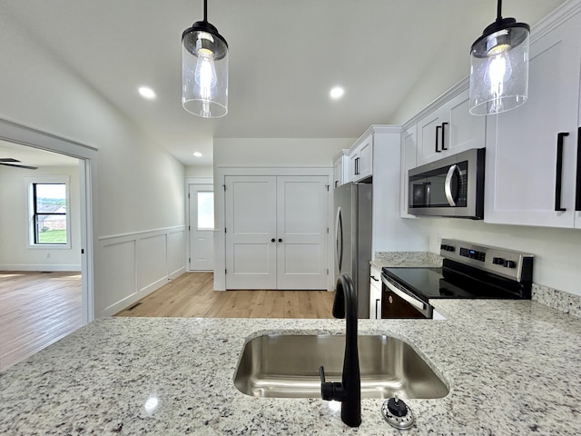 1403 Kit Cowan Rd, Somerset, KY 42503 - kitchen featuring light stone counters, white cabinetry, light wood-style flooring, a sink, and stainless steel appliances