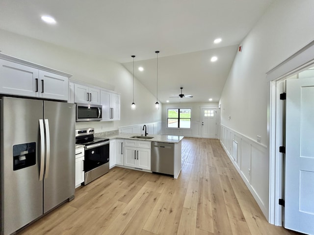 1403 Kit Cowan Rd, Somerset, KY 42503 - kitchen with a sink, stainless steel appliances, a peninsula, wainscoting, and lofted ceiling