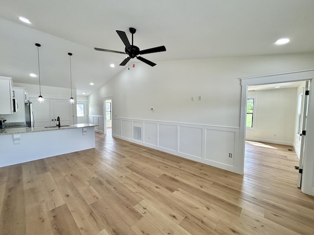 1403 Kit Cowan Rd, Somerset, KY 42503 - unfurnished living room with recessed lighting, light wood-type flooring, a wainscoted wall, a sink, and visible vents