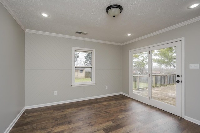 unfurnished room featuring visible vents, dark wood finished floors, and crown molding