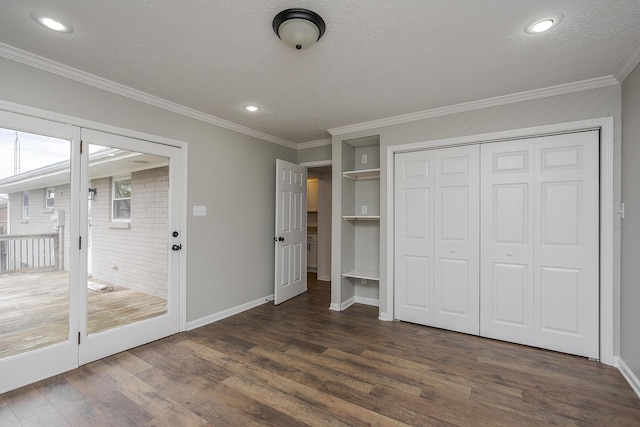 unfurnished bedroom featuring a textured ceiling, crown molding, baseboards, and dark wood-style flooring