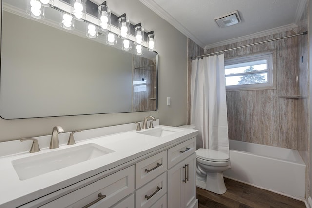 bathroom with crown molding, toilet, visible vents, and a sink