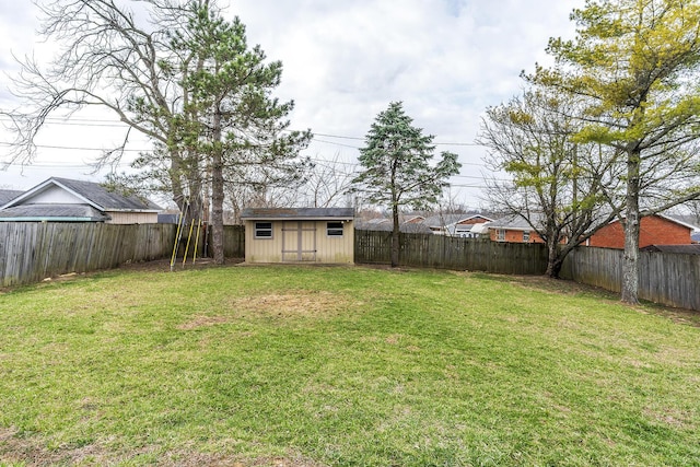 view of yard featuring an outbuilding, a shed, and a fenced backyard