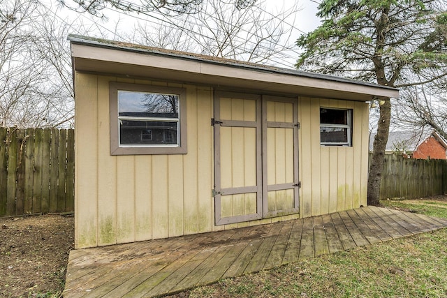 view of shed featuring fence