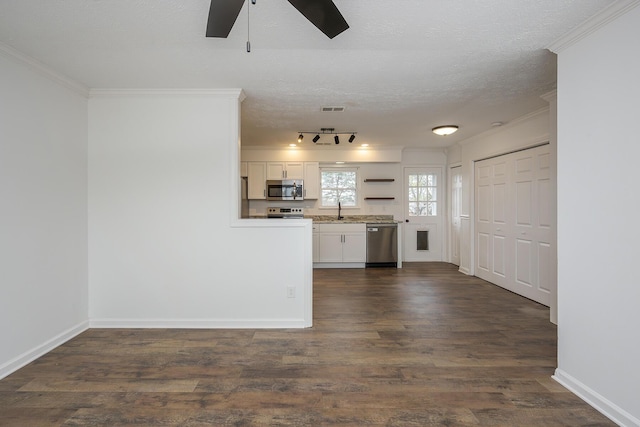 kitchen featuring white cabinetry, dark wood-type flooring, visible vents, and appliances with stainless steel finishes