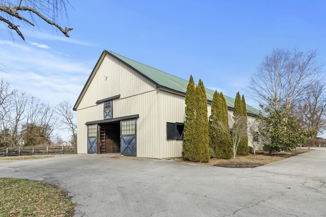 view of outbuilding with an outbuilding and fence