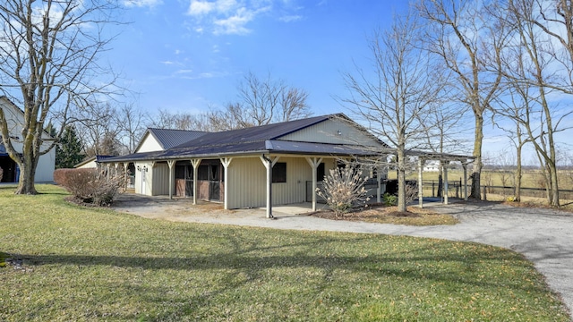 view of front of house featuring aphalt driveway and metal roof