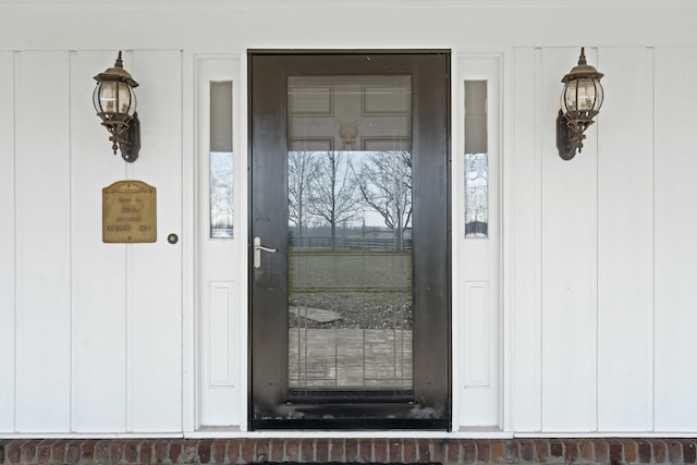 view of exterior entry featuring board and batten siding