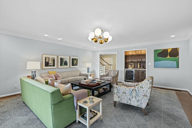 living area with crown molding, baseboards, beverage cooler, dark wood finished floors, and an inviting chandelier