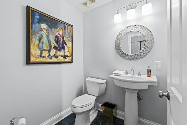 half bathroom featuring tile patterned floors, visible vents, toilet, and baseboards