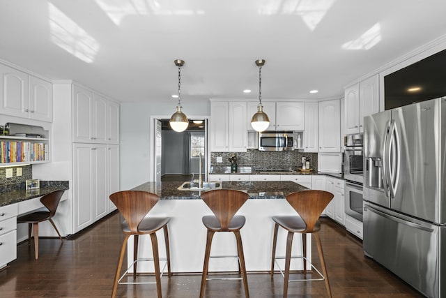 kitchen with a sink, dark wood-type flooring, appliances with stainless steel finishes, and white cabinets