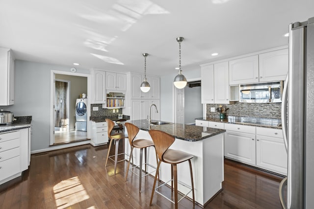 kitchen featuring a sink, white cabinets, washer / clothes dryer, and stainless steel appliances