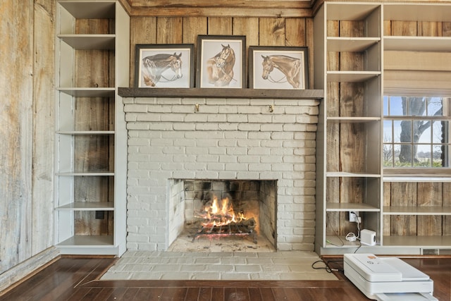 room details featuring a brick fireplace and wood finished floors