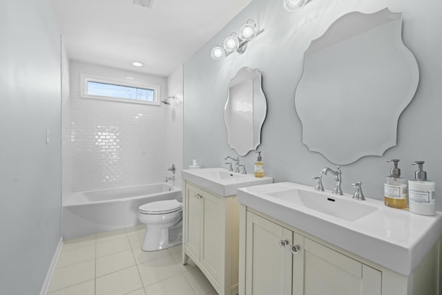 full bathroom featuring two vanities, a sink, shower / washtub combination, tile patterned floors, and toilet