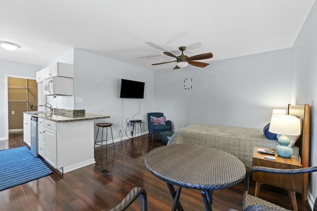 bedroom with a sink, baseboards, ceiling fan, and dark wood-style flooring