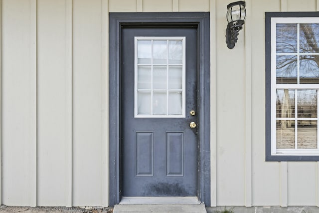 view of exterior entry featuring board and batten siding