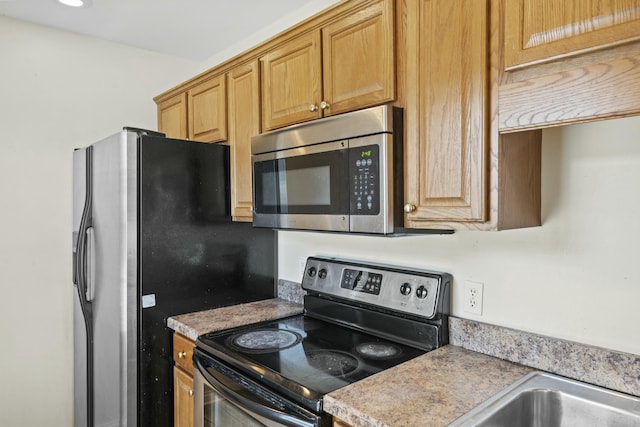 kitchen with light countertops and appliances with stainless steel finishes