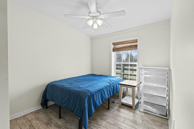 bedroom with ceiling fan, baseboards, and wood finished floors